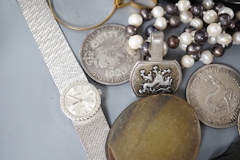 A collection of coins, magnifying loupes, cultured pearl necklace, etc.